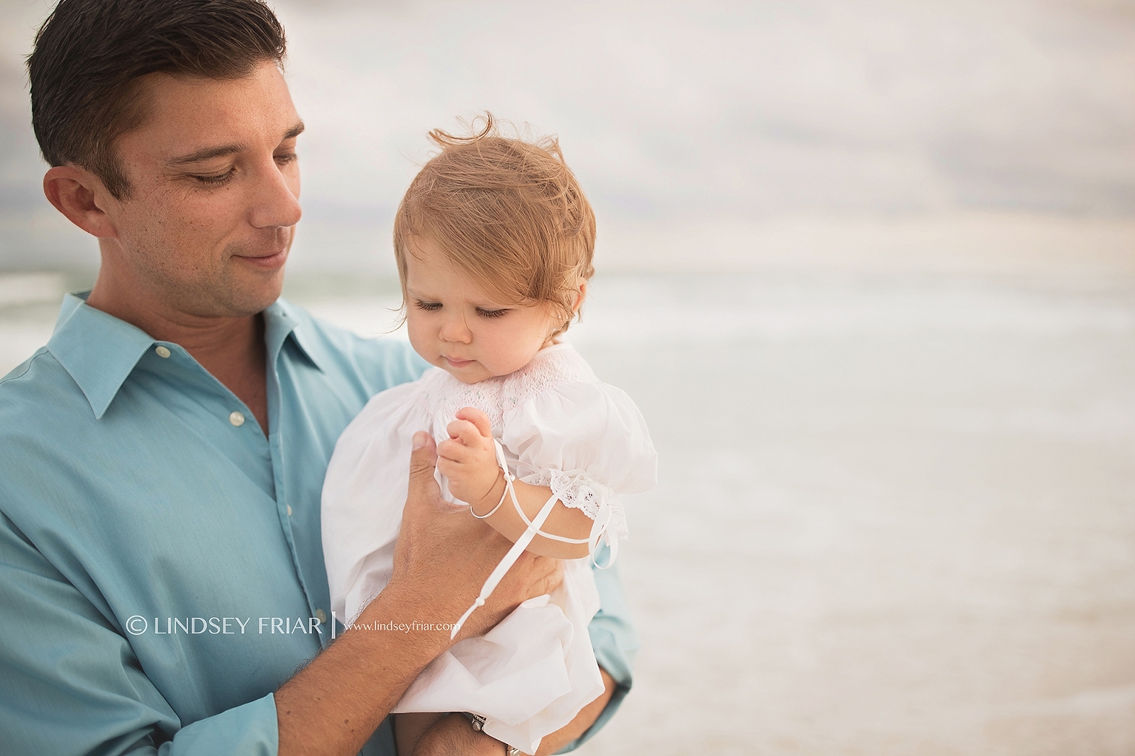 Daddy holding his little girl on Pensacola Beach