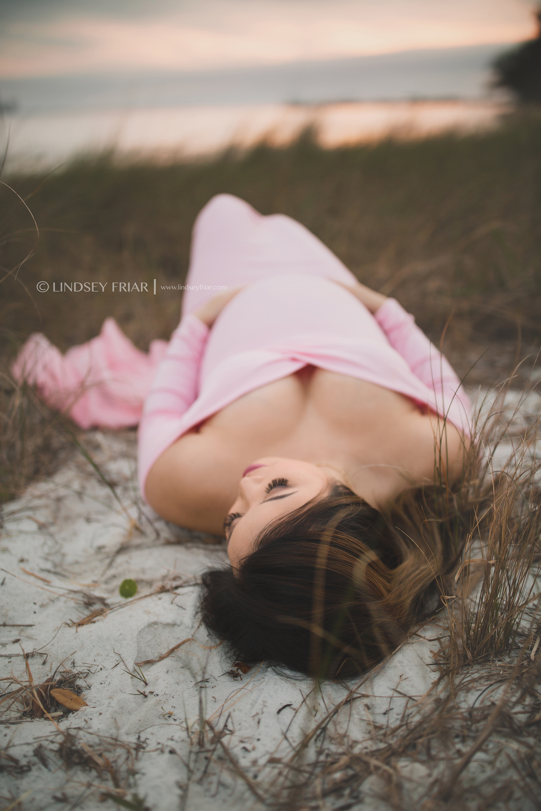 pregnant mama showing off her bump by laying on the ground