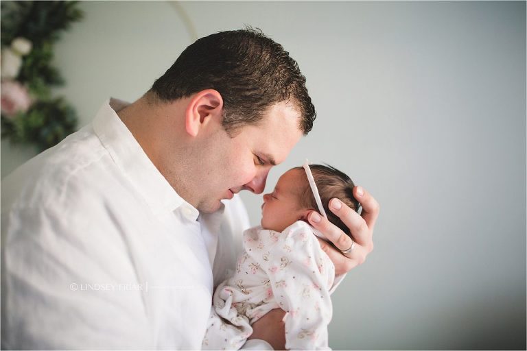 daddy and his newborn girl nose to nose