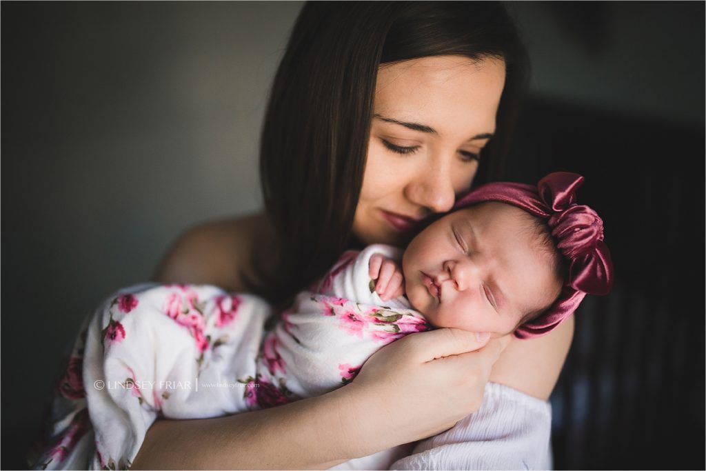 photo of mama holding her brand new baby girl