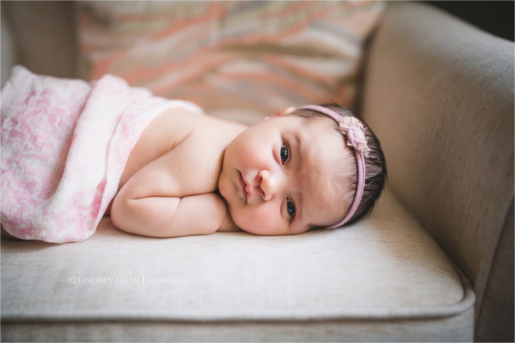 newborn laying on her tummy with eyes wide open