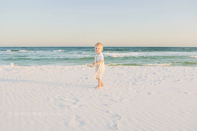 blonde hair blue eye boy standing in front of Gulf of Mexico
