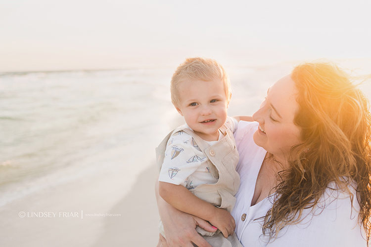 mother looking adoringly at her child on the beach