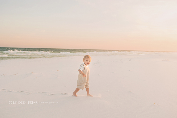 little boy walking on the beach