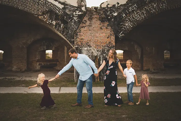 little girl pulling her family in line in front of the fort at fort pickens