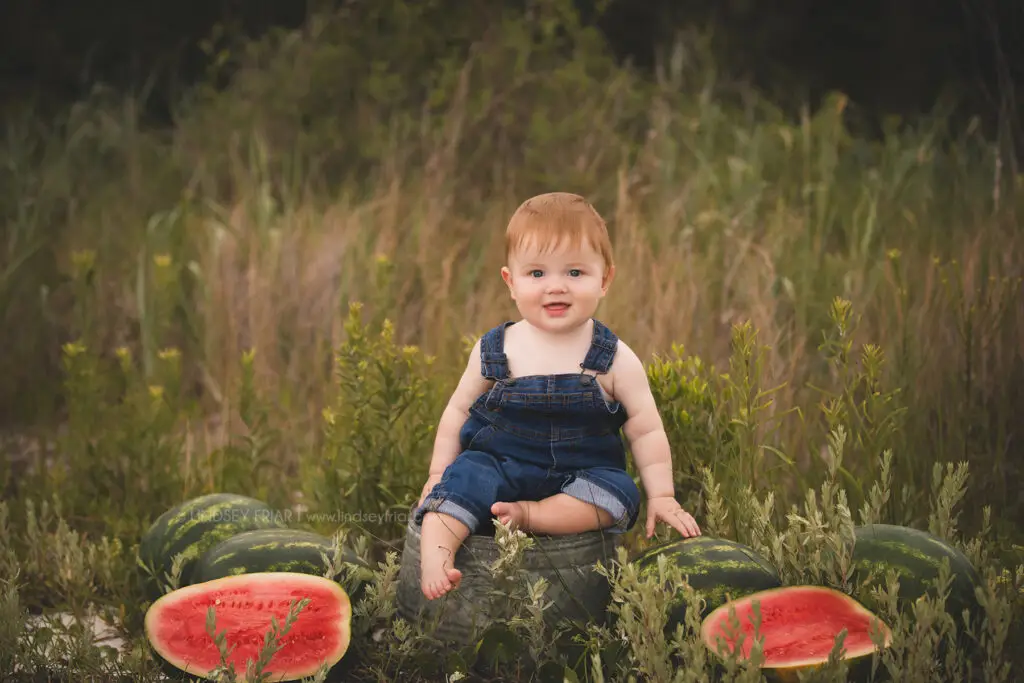 boy sitting with some watermelon