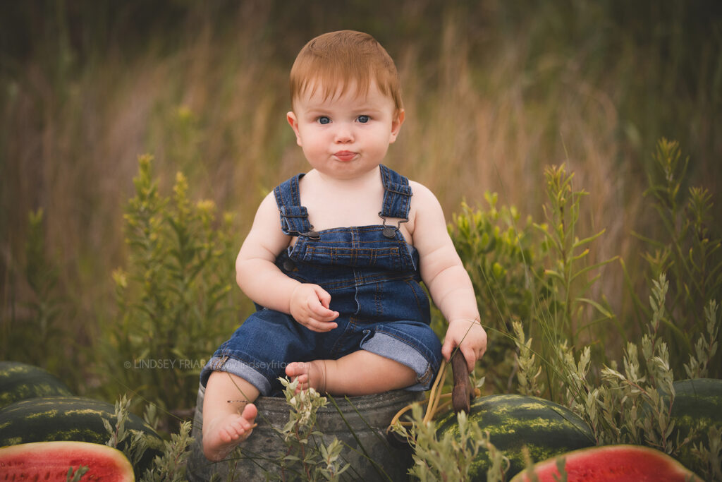 boy sitting with some watermelon